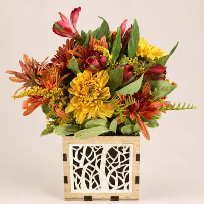 Autumn bouquet of yellow and orange flowers in a decorative wooden box