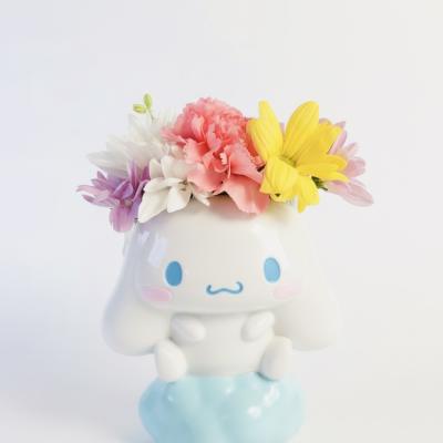 Colorful flowers arranged in a cute ceramic character planter