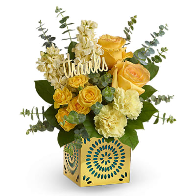 Yellow and cream flower arrangement with thanks pick in a yellow patterned cube container