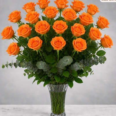 Orange roses arranged in a clear glass vase