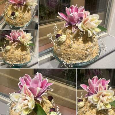 Tiered cake with pink and white flowers on top
