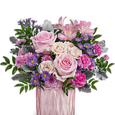 Pink and purple mixed bouquet in a pink glass vase