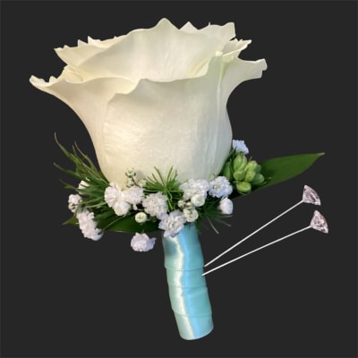 White calla lily boutonniere with small white flowers and blue ribbon wrap