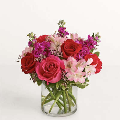 Pink and red rose bouquet in a clear glass vase