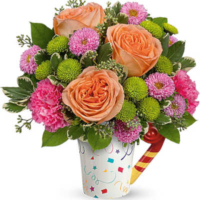 Peach roses and pink pom flowers in a festive printed mug