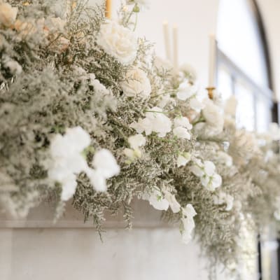 White floral arrangement with cascading blooms and soft greenery