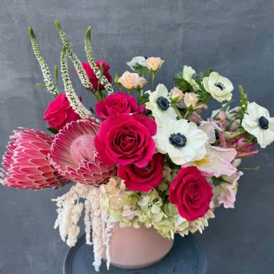 Pink roses and white anemones in a blush vase