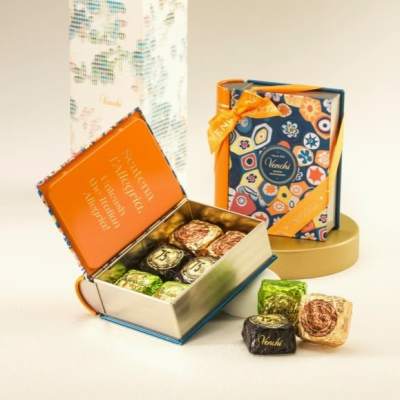 Open gift boxes of assorted chocolates with colorful wrappers