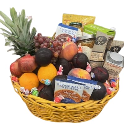 Fruit and snack gift basket with pineapple, grapes, oranges, and packaged treats