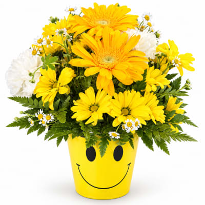 Yellow and white flowers in a smiley-face pot