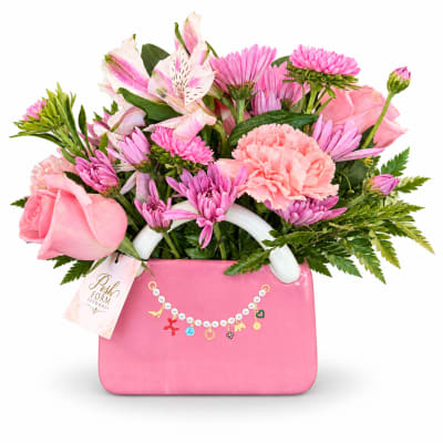 Pink mixed bouquet in a pink handbag-shaped container