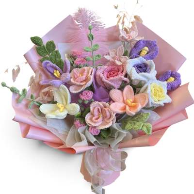 Bouquet of pastel crocheted flowers wrapped in pink paper