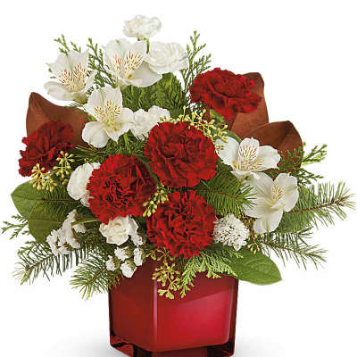Red and white floral arrangement in a red glass vase