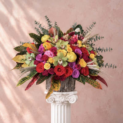 Colorful bouquet of roses and orchids in a rustic container