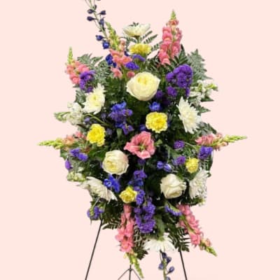 Standing floral spray with white, pink, yellow, and purple flowers