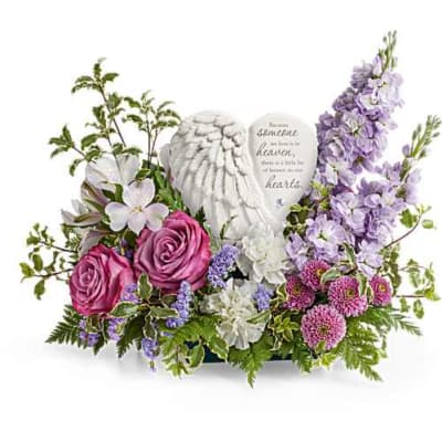 Pink roses and lavender flowers arranged around memorial stones