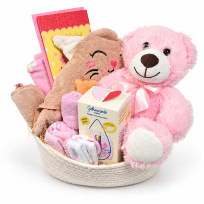 Gift basket with pink teddy bear, baby items, and a card