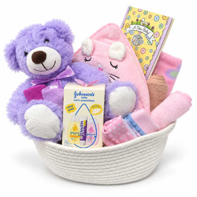 Baby gift basket with plush toys, blankets, and care items