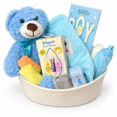 Baby gift basket with a teddy bear, blanket, card, and care items