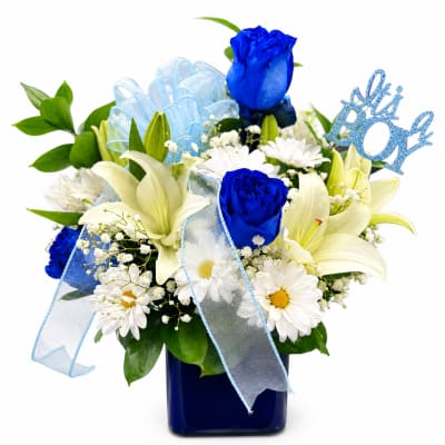Blue and white floral arrangement in a dark vase with a "Boy" pick