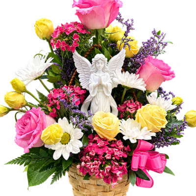 Basket arrangement of pink and yellow roses with daisies and an angel figurine