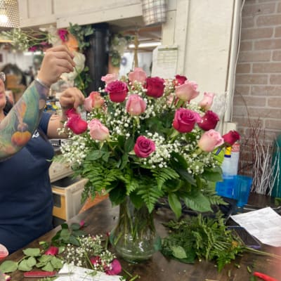 Pink and red rose arrangement in a glass vase