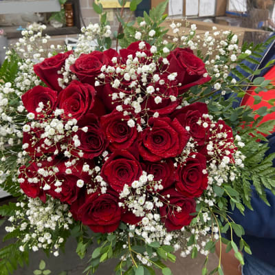 Bouquet of red roses with white baby's breath and greenery