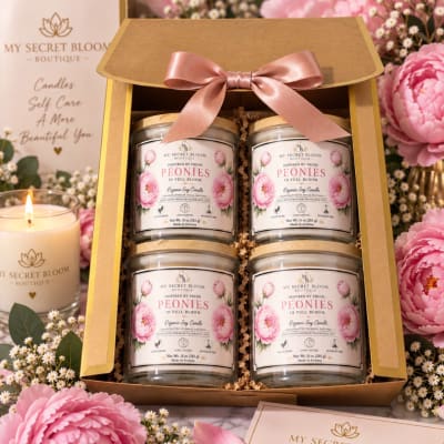 Gift box with four peony-scented candles and a pink ribbon