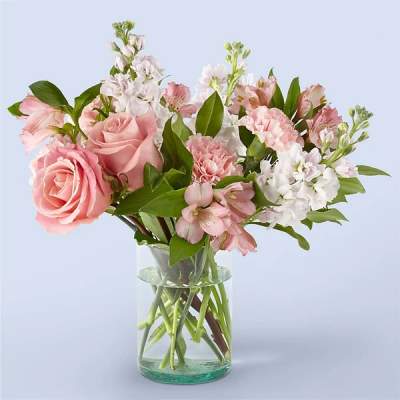 Pink and white mixed bouquet in a clear glass vase