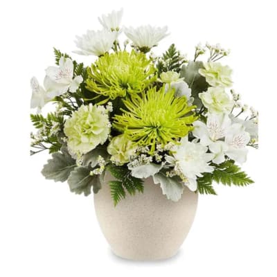 White and lime-green floral arrangement in a beige vase