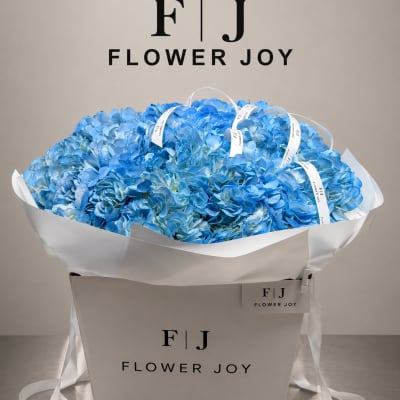 Large bouquet of blue hydrangeas in a white gift box