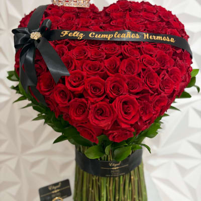 Heart-shaped bouquet of red roses with a black ribbon and birthday banner