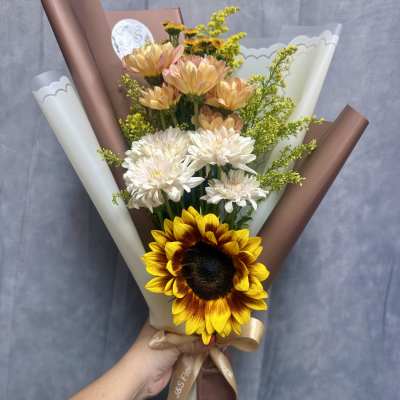 Handheld bouquet with a sunflower, white chrysanthemums, and peach blooms