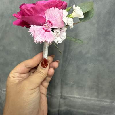 Hot pink spray roses with white boutonnière