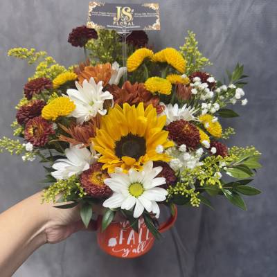 Mixed bouquet with a sunflower in a red mug