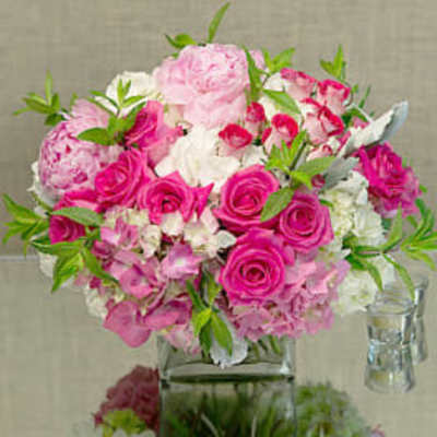 Pink and white flower arrangement in a clear glass vase
