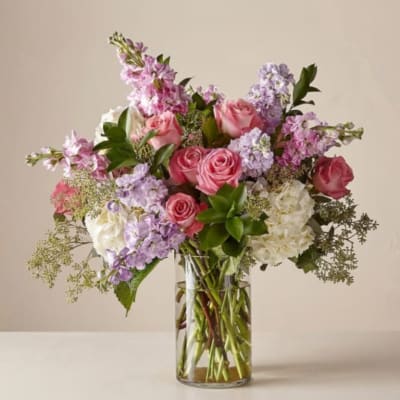 Pink and lavender mixed bouquet in a clear glass vase