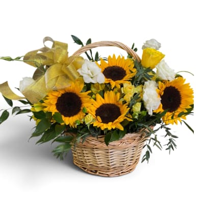Sunflowers and white roses in a wicker basket with a gold ribbon