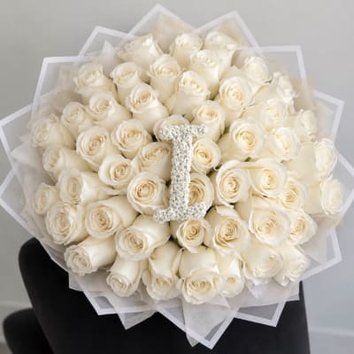 Bouquet of white roses with a jeweled letter I centerpiece