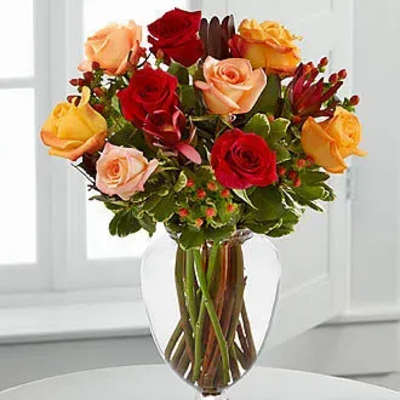 Mixed roses in a clear glass vase