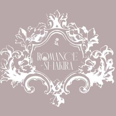 Decorative gift card with ornate white floral frame and Romance by Shakira text