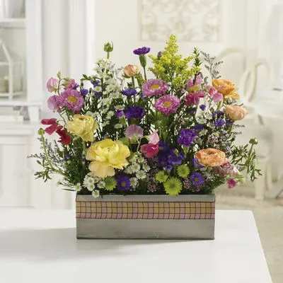 Mixed bouquet in a rectangular box with pink, purple, yellow, and peach flowers