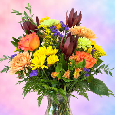 Colorful mixed bouquet in a clear glass vase