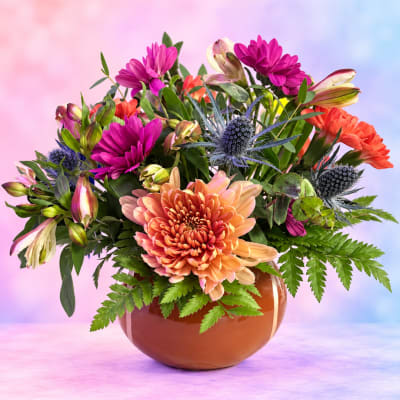 Colorful mixed bouquet in a round brown vase