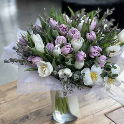 Bouquet of pink and white tulips in a glass vase