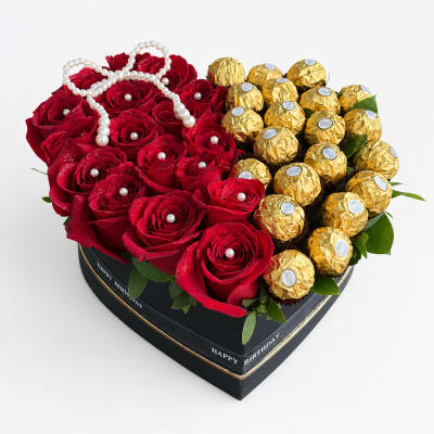Heart-shaped box with red roses and gold-wrapped chocolates
