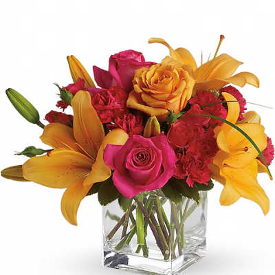 Pink roses and yellow lilies in a clear glass vase
