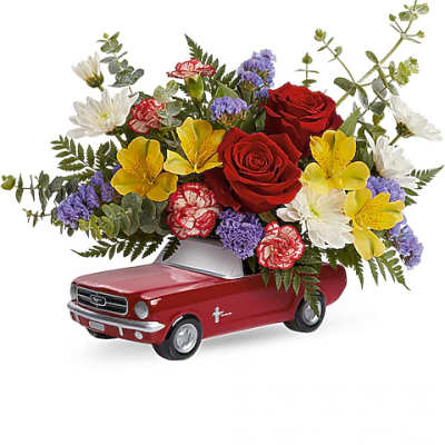 Flower arrangement in a red toy pickup truck