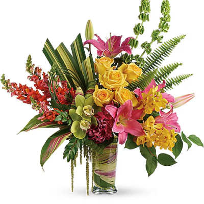 Tropical bouquet with pink lilies, yellow roses, and orchids in a glass vase