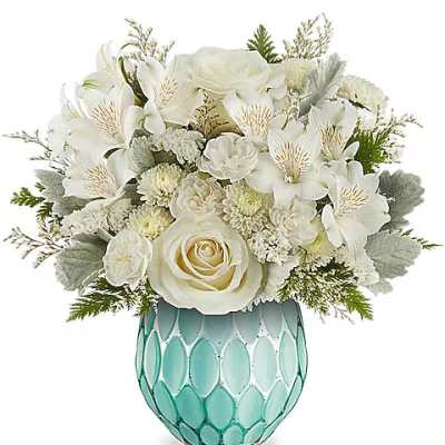 White floral arrangement in a turquoise glass vase